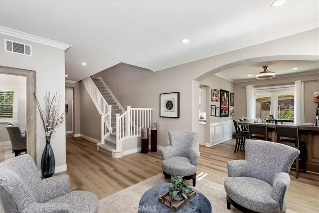 a living room with furniture and a potted plant