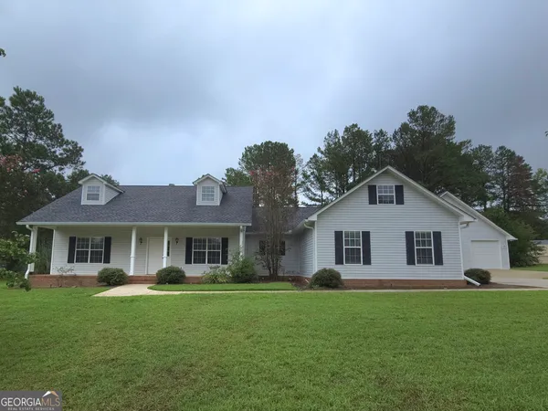 a front view of a house with a garden