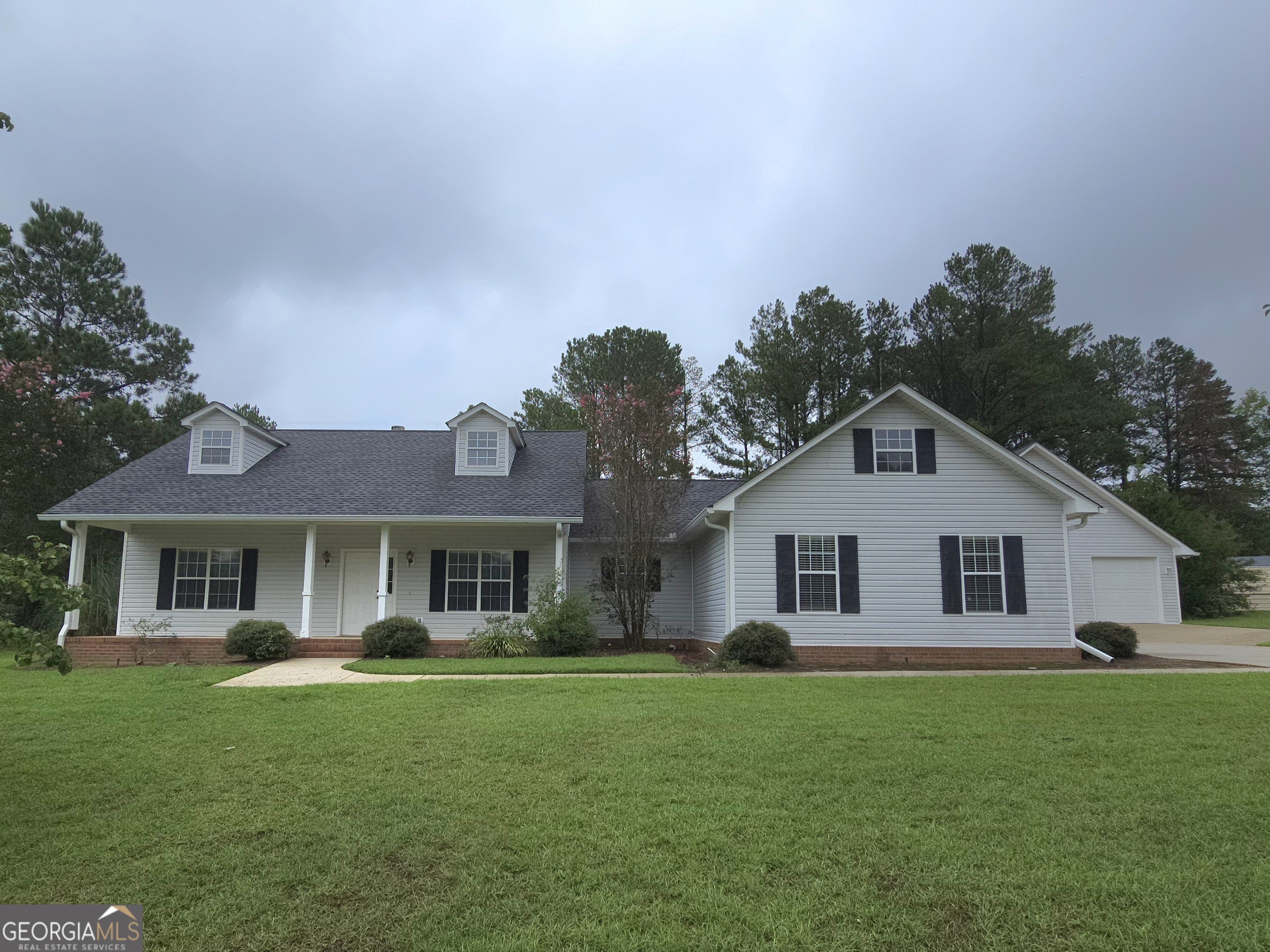 a front view of a house with a garden