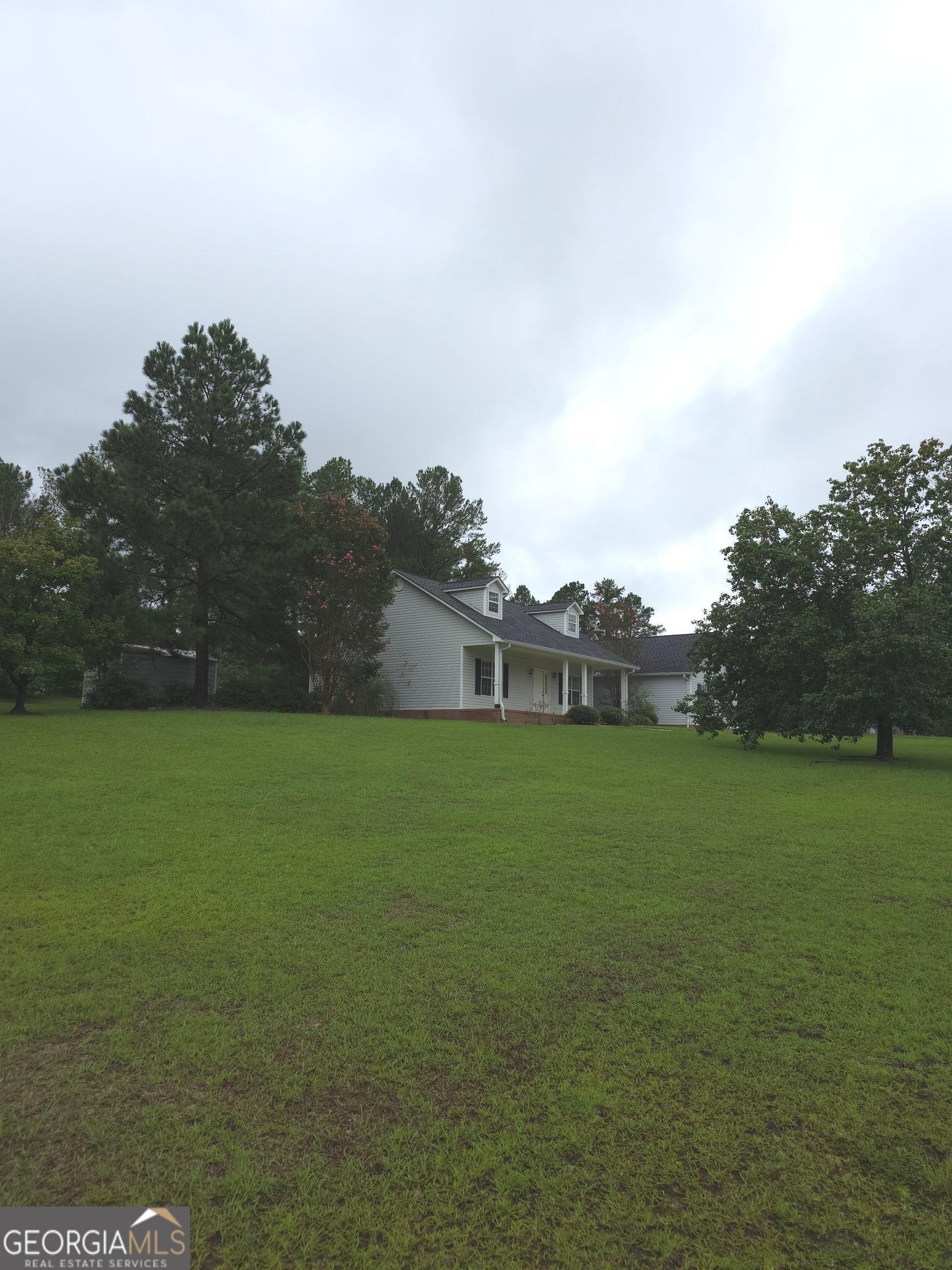 103 Windy Hill Court Dublin, GA 31021 - Photo 13 of 13 a view of a field of grass and trees