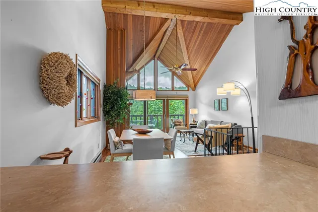 a living room with furniture a fireplace and a large window