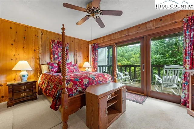 a bed room with a bed and a chandelier