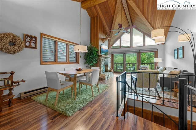a view of a dining room with furniture a chandelier and wooden floor