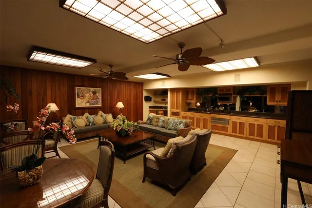 a living room with furniture a chandelier and a large window