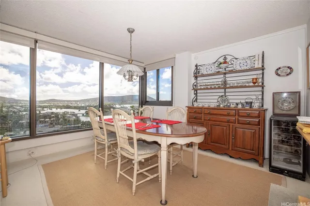 a dining room with furniture a chandelier and window