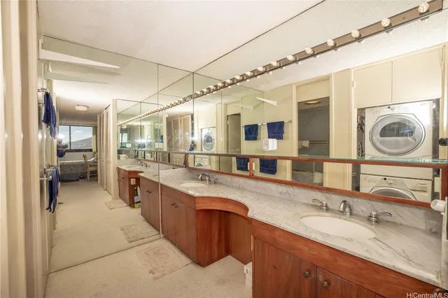 a large bathroom with a granite countertop double vanity and a mirror
