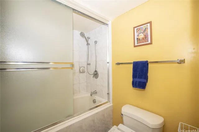 a bathroom with a shower and a toilet