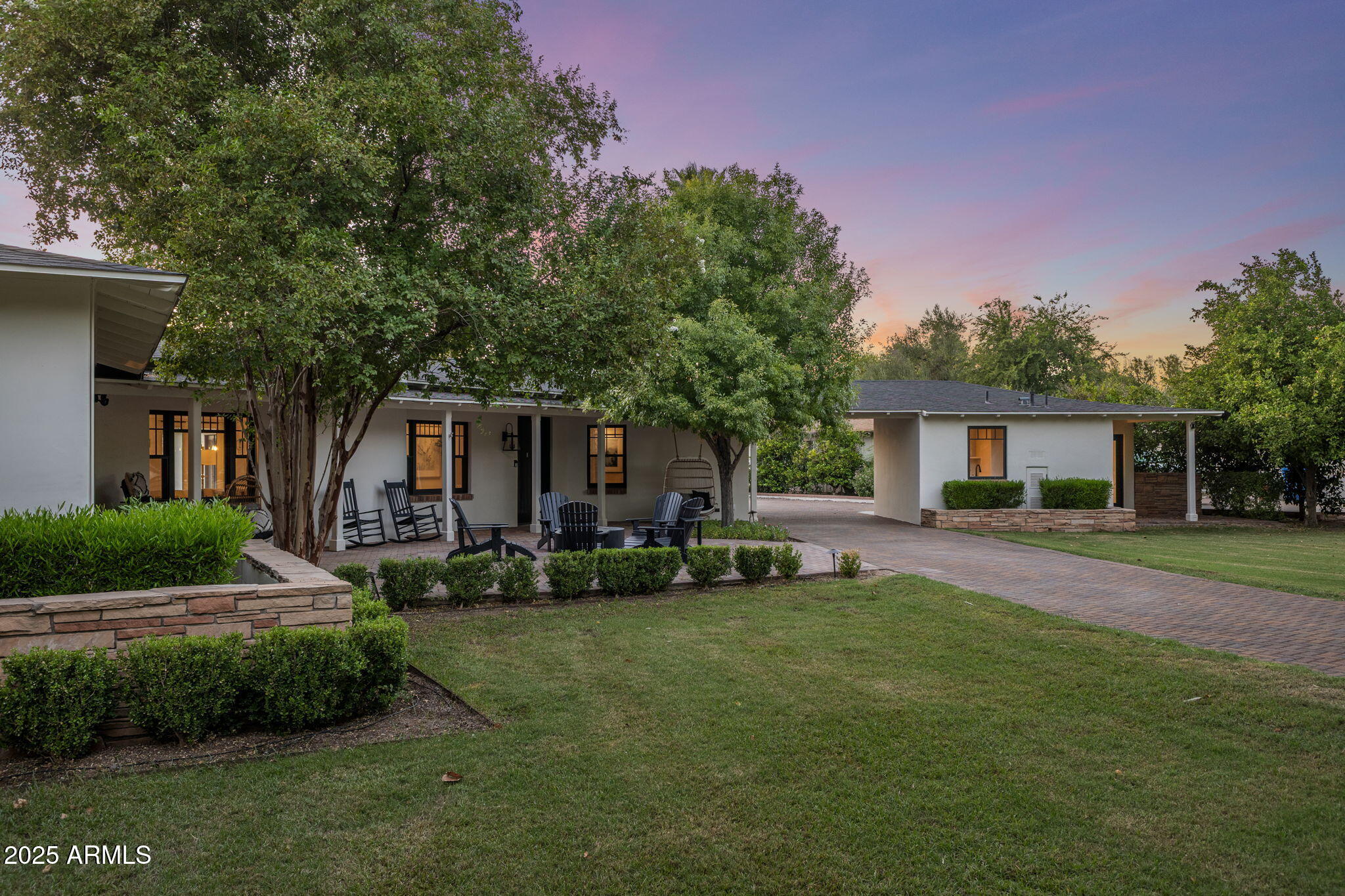 7030 North Wilder Road Phoenix, AZ 85021 - Photo 2 of 70 a front view of a house with a garden and trees