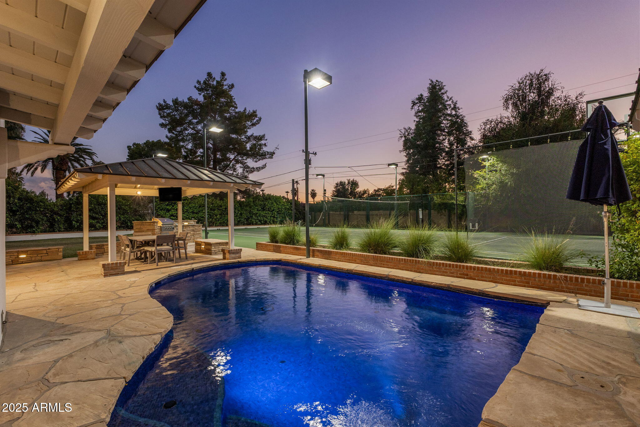 7030 North Wilder Road Phoenix, AZ 85021 - Photo 21 of 70 a view of pool with table and chairs under an umbrella