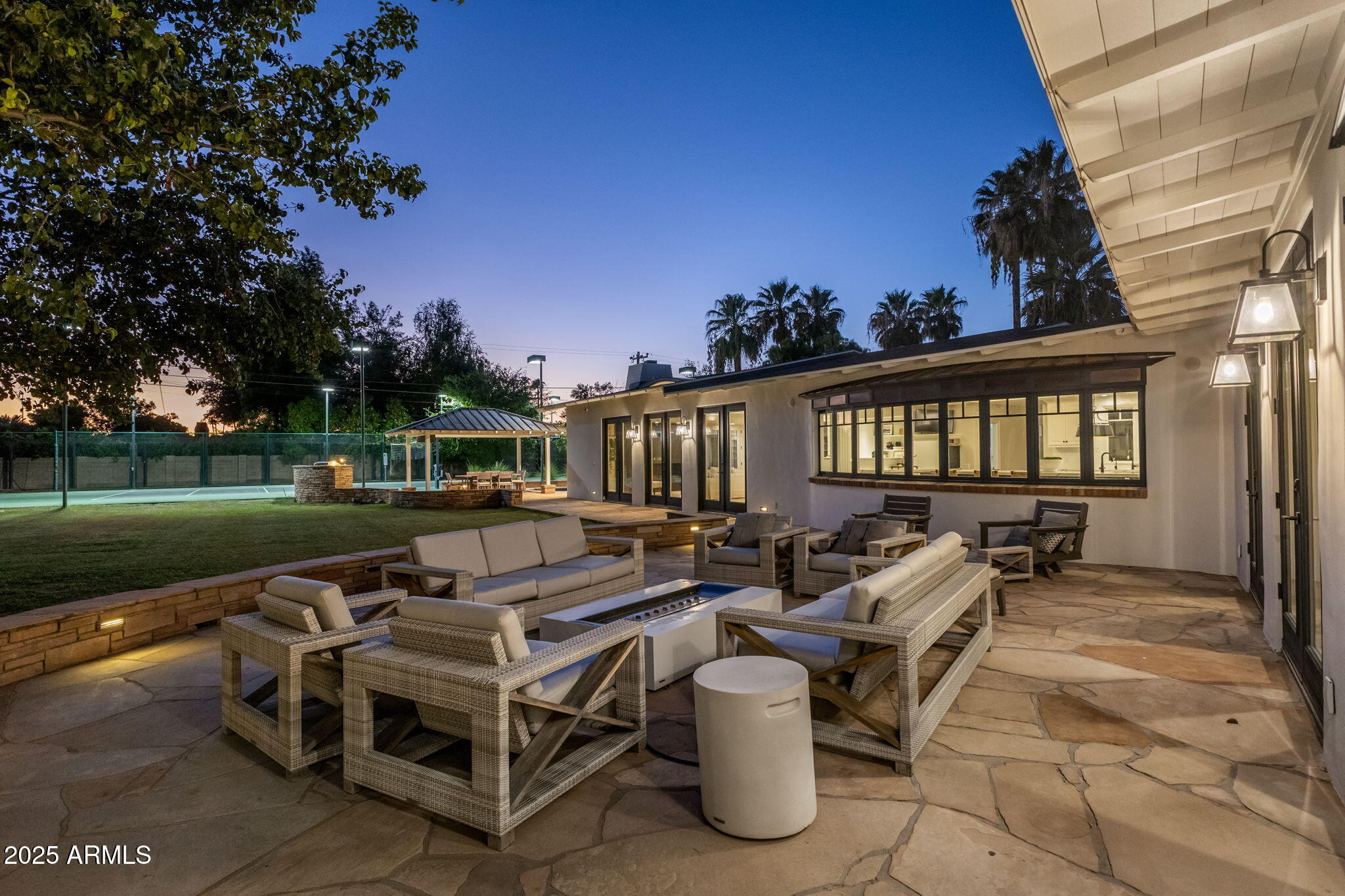 7030 North Wilder Road Phoenix, AZ 85021 - Photo 24 of 70 a view of a patio with table and chairs with wooden floor and fence