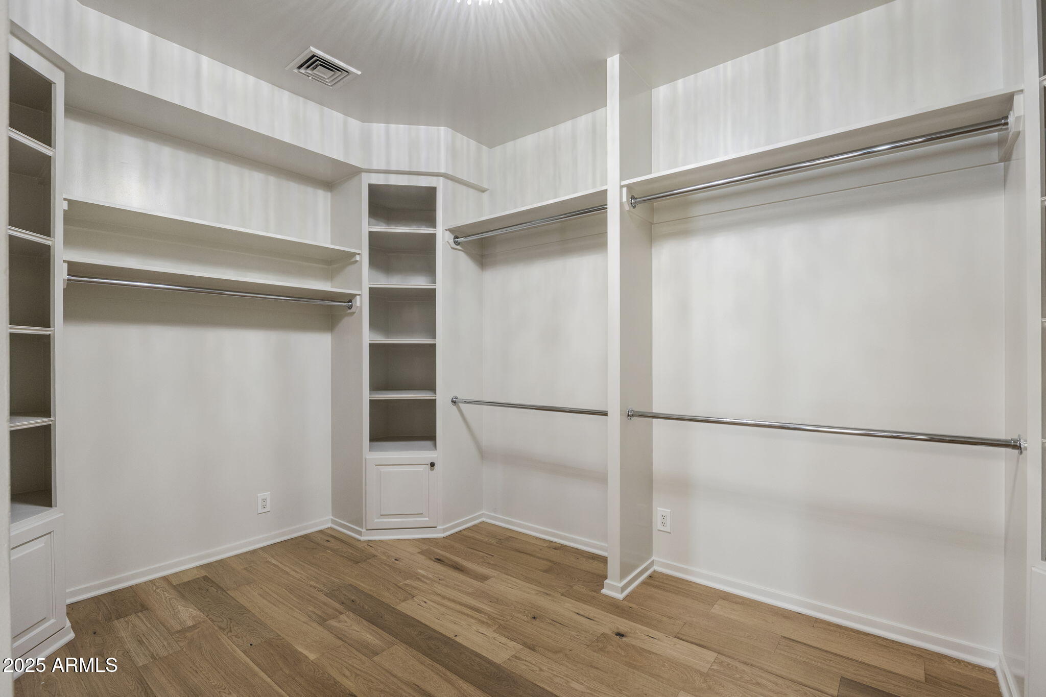 7030 North Wilder Road Phoenix, AZ 85021 - Photo 56 of 70 a view of an empty room with wooden floor and closet