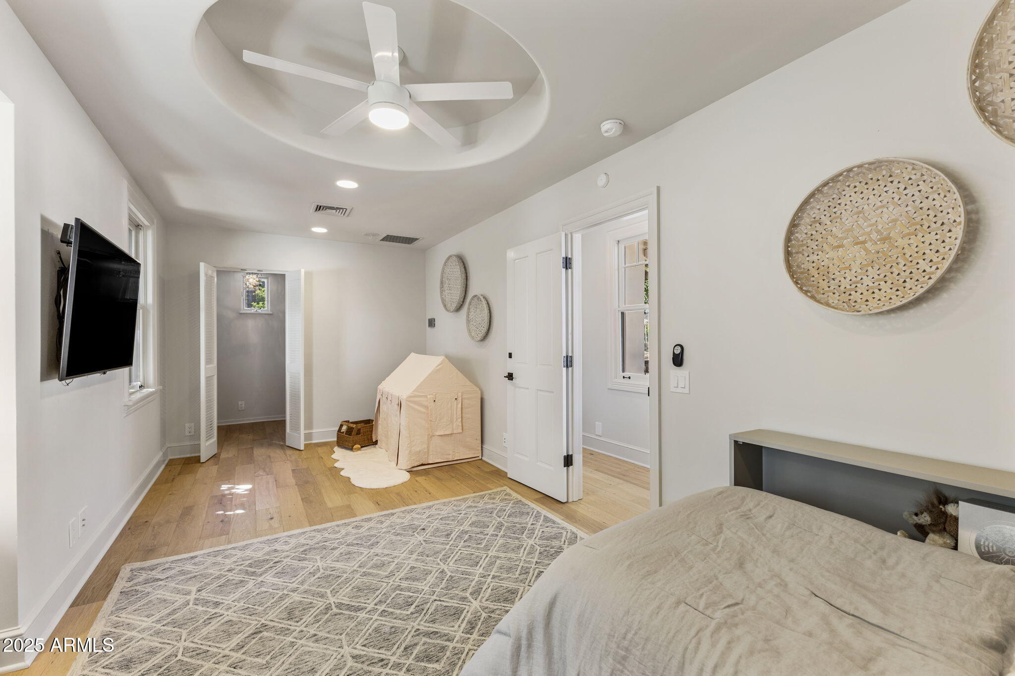 7030 North Wilder Road Phoenix, AZ 85021 - Photo 62 of 70 a bedroom with a large bed and a chandelier