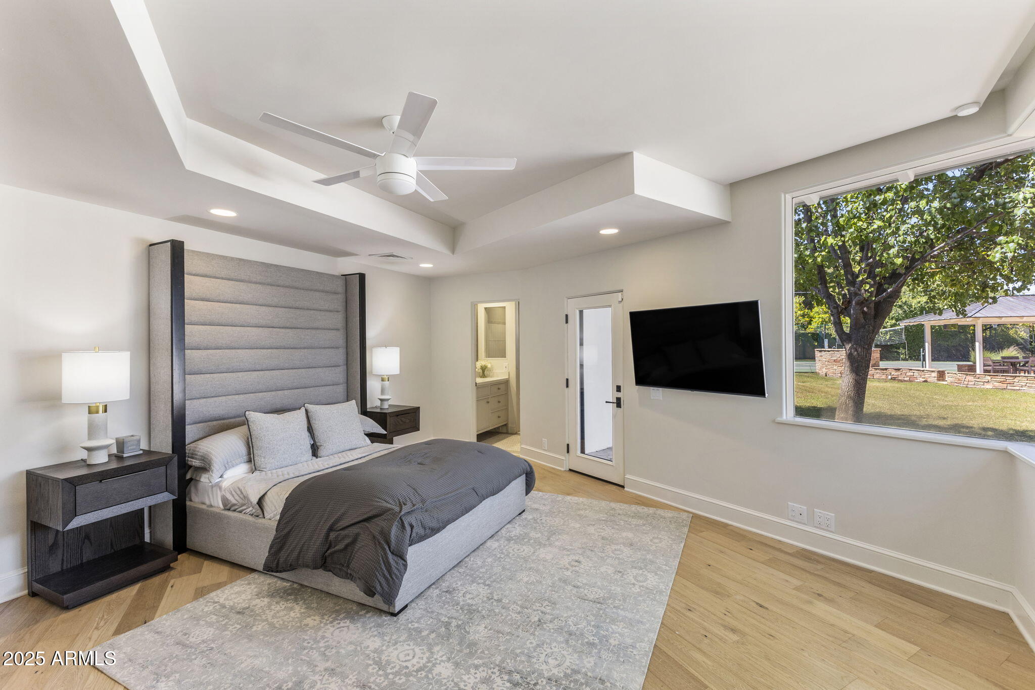 7030 North Wilder Road Phoenix, AZ 85021 - Photo 64 of 70 a spacious bedroom with a large bed and a flat screen tv