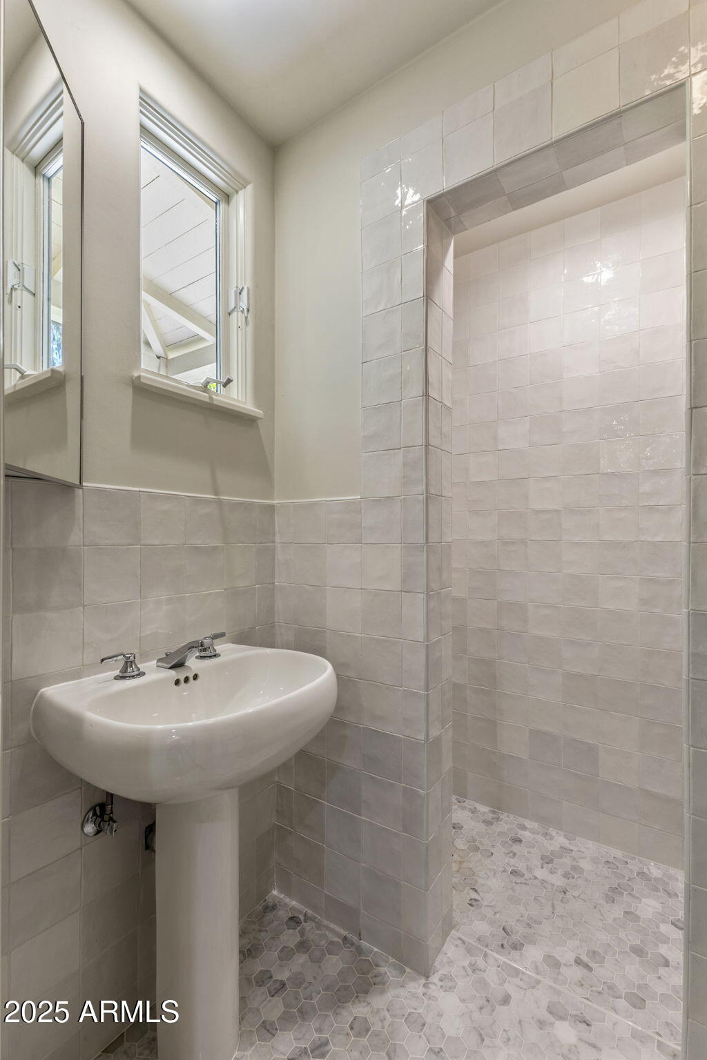 7030 North Wilder Road Phoenix, AZ 85021 - Photo 69 of 70 a bathroom with a sink a mirror and a shower