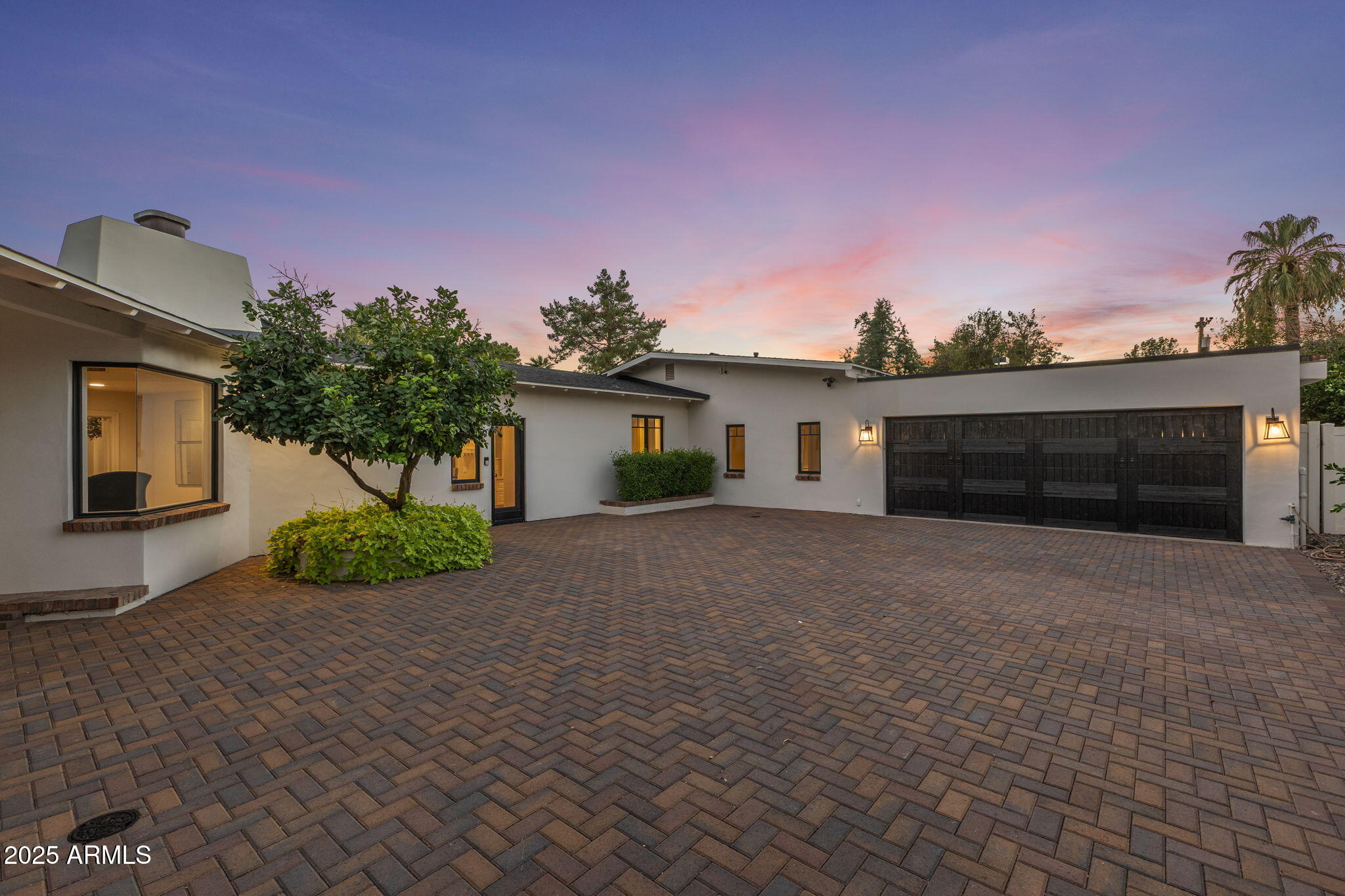7030 North Wilder Road Phoenix, AZ 85021 - Photo 7 of 70 a front view of a house with a yard and a garage