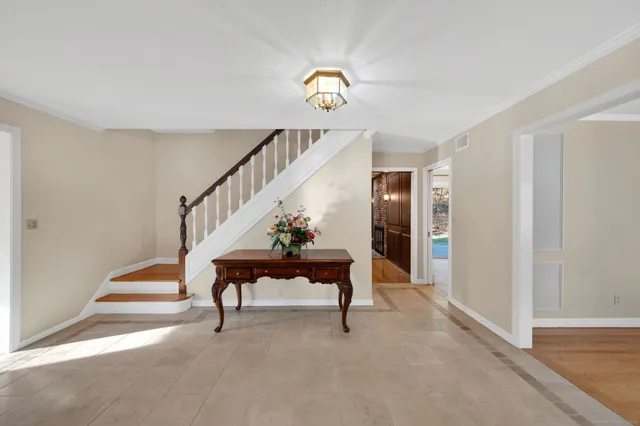 a view of entryway and hall with a front door