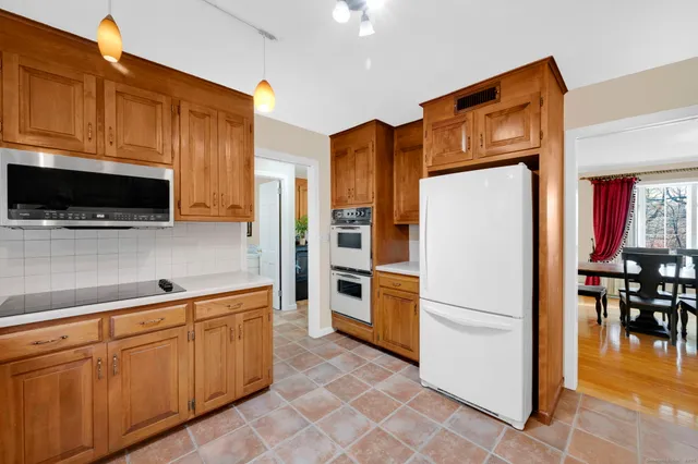 a kitchen with stainless steel appliances a refrigerator and a stove top oven
