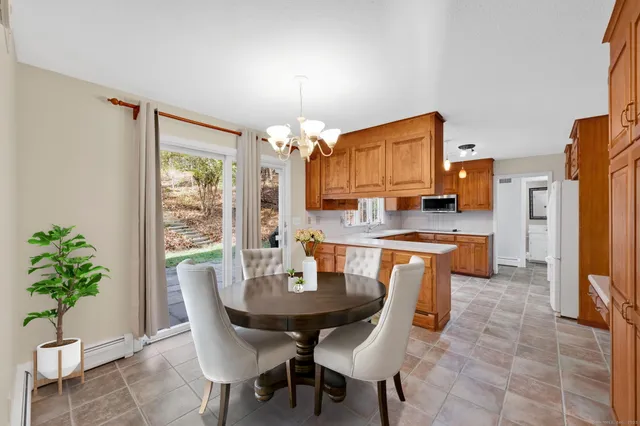 a view of a dining room with furniture and a chandelier