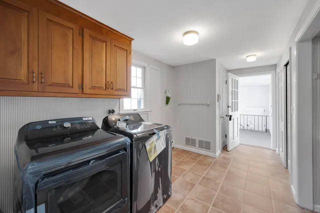 a bathroom with a toilet sink vanity and mirror