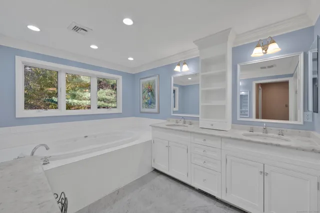 a bathroom with a granite countertop sink mirror and double