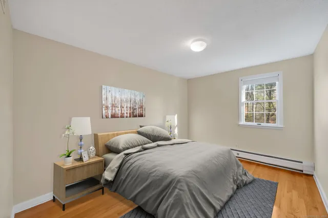 a bathroom with a double vanity sink a mirror and a bathtub