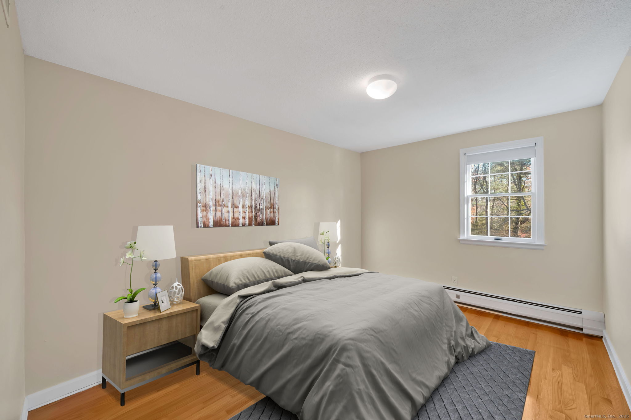 75 Arlen Way West Hartford, CT 06117 - Photo 29 of 39 a bedroom with a bed and wooden floor