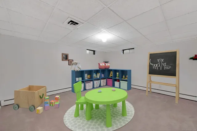 a bathroom with a granite countertop sink toilet and mirror