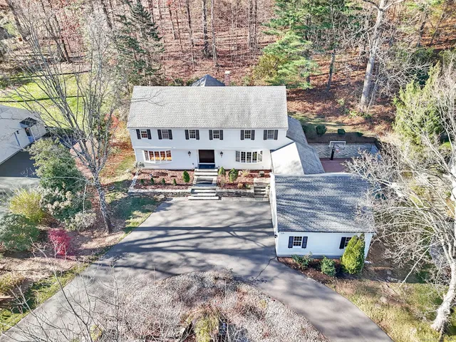 an aerial view of a house with a yard