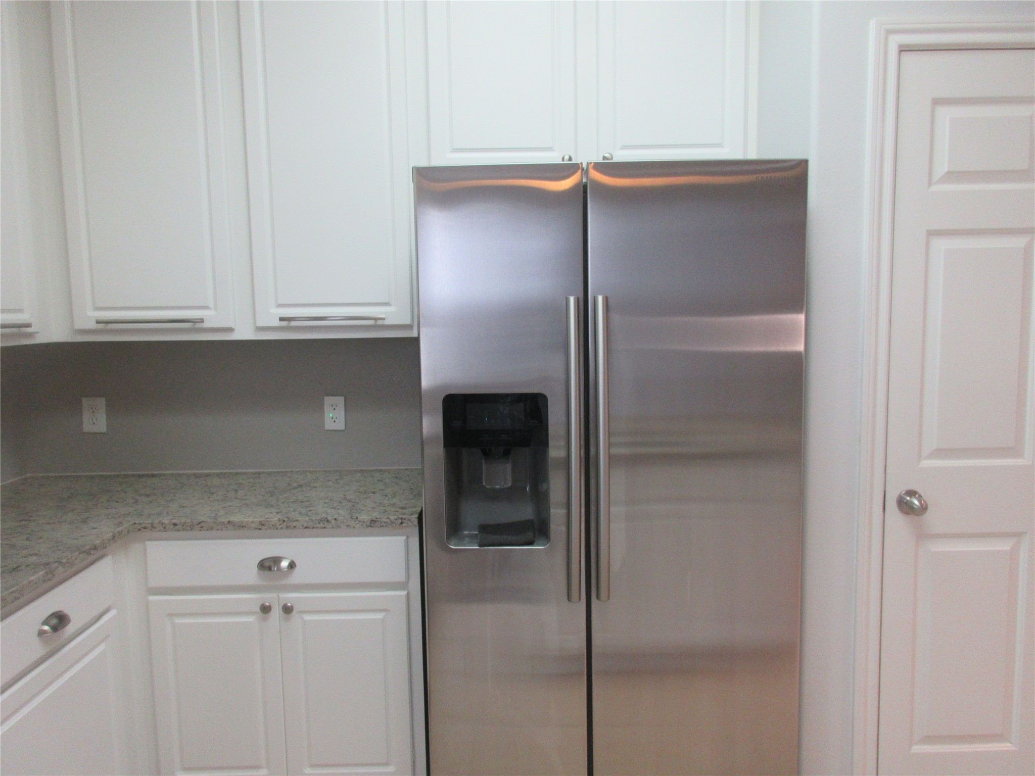 17522 Bering Bridge Lane Humble, TX 77346 - Photo 5 of 16 a kitchen with a refrigerator and cabinets