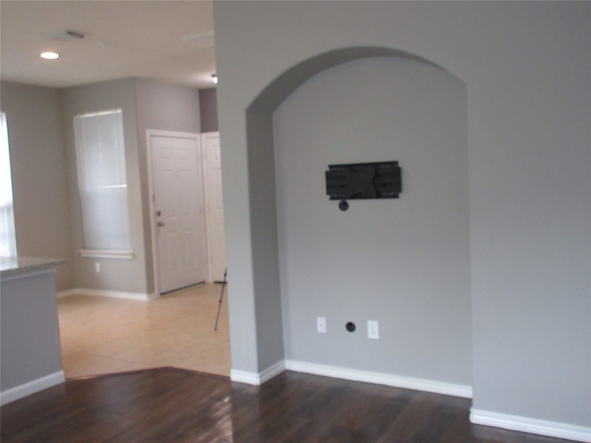 17522 Bering Bridge Lane Humble, TX 77346 - Photo 6 of 16 an empty room with wooden floor and windows