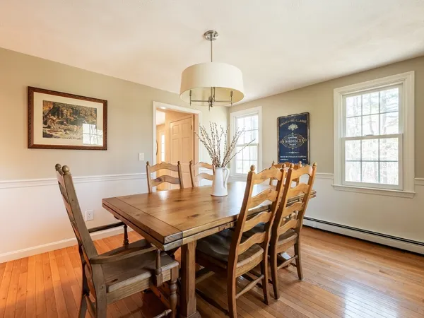 a dining room with furniture and wooden floor