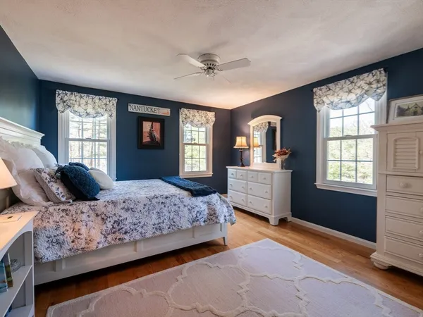 a bedroom with a large bed and a dresser