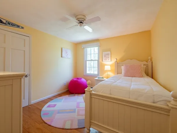 a spacious bedroom with a bed and a dresser