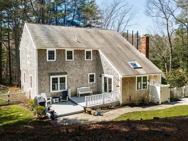 a view of a house with backyard and sitting area