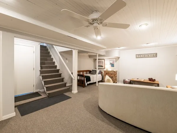 a bedroom with a bed next to a window and a chandelier