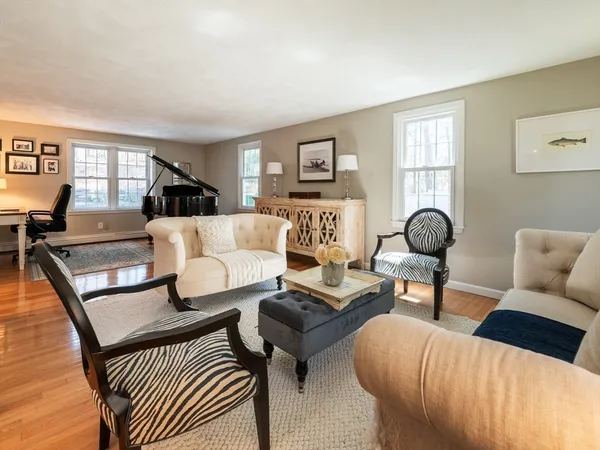 a living room with furniture a wooden floor and a window