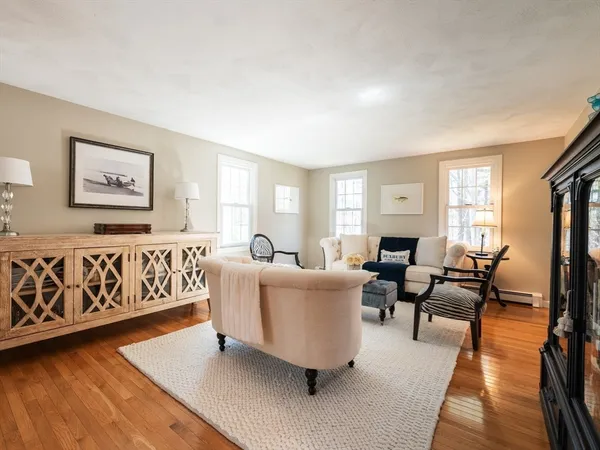 a living room with furniture and a wooden floor