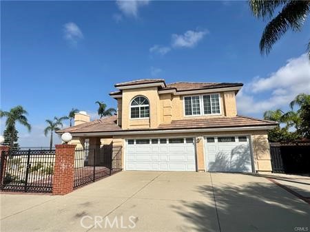 a front view of a house with a garage and balcony