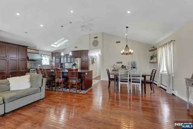 a living room with furniture kitchen view and a dining table