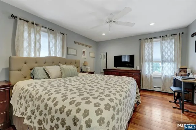 a large bedroom with a bed and large windows