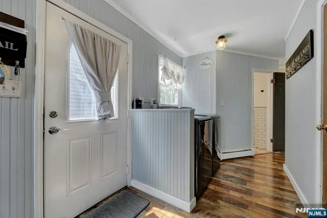 a view of hallway with wooden floor and staircase