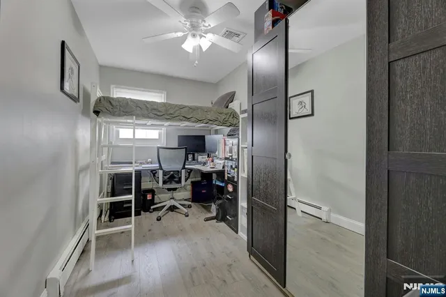 a view of a livingroom with furniture and a ceiling fan