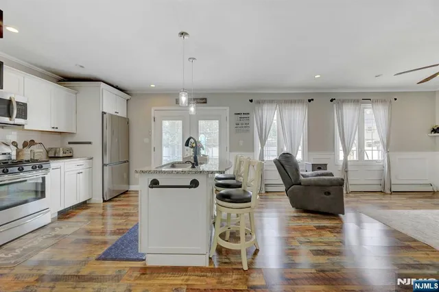 a living room with furniture and kitchen view