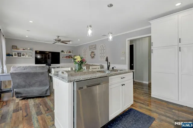 a spacious bathroom with a granite countertop sink and a mirror