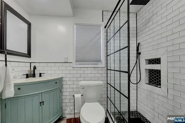 a bathroom with a toilet sink and mirror