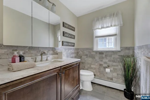 a kitchen with a sink and a toilet