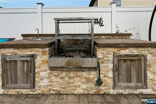 a kitchen with granite countertop a stove and cabinets