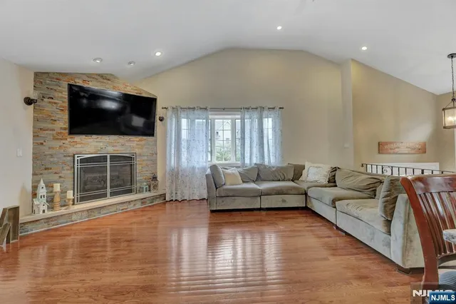 a living room with fireplace furniture and a flat screen tv