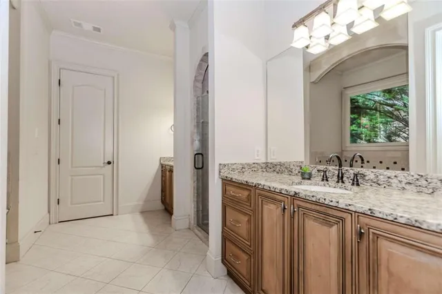 a bathroom with a sink vanity and a mirror