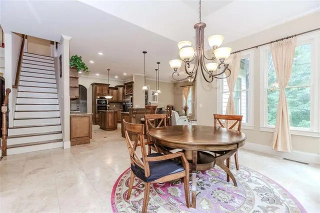 a dining room with furniture and a chandelier
